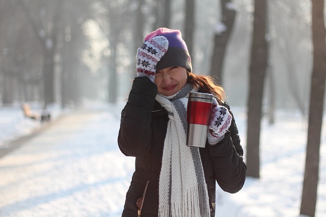 woman with hot tea in snow