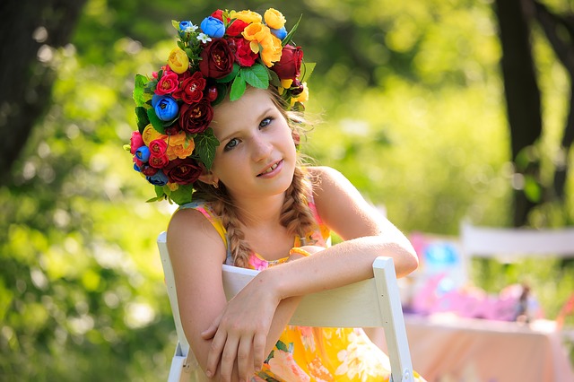 small girl wearing a flower hat