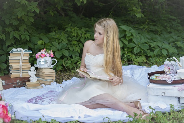 girl tea party in white dress reading a book
